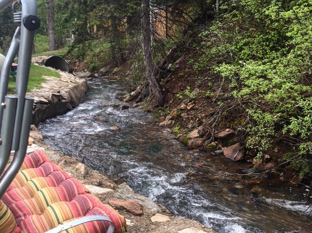 View of Whitetail creek that runs behind the cabins, motel rooms, and RV sites